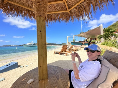 Kim Bello sitting on the beach
